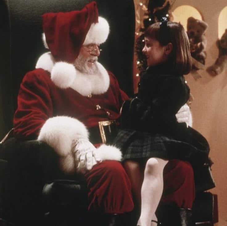 _ Santa Claus with a little girl on his lap, smiling together during Christmas festivities indoors. | Sky Rye Design Santa Claus with a little girl on his lap, smiling together during Christmas festivities indoors.