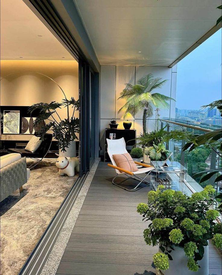 _ Modern balcony with plants, lounge chair, and city view, blending indoor and outdoor living spaces seamlessly. | Sky Rye Design Modern balcony with plants, lounge chair, and city view, blending indoor and outdoor living spaces seamlessly.