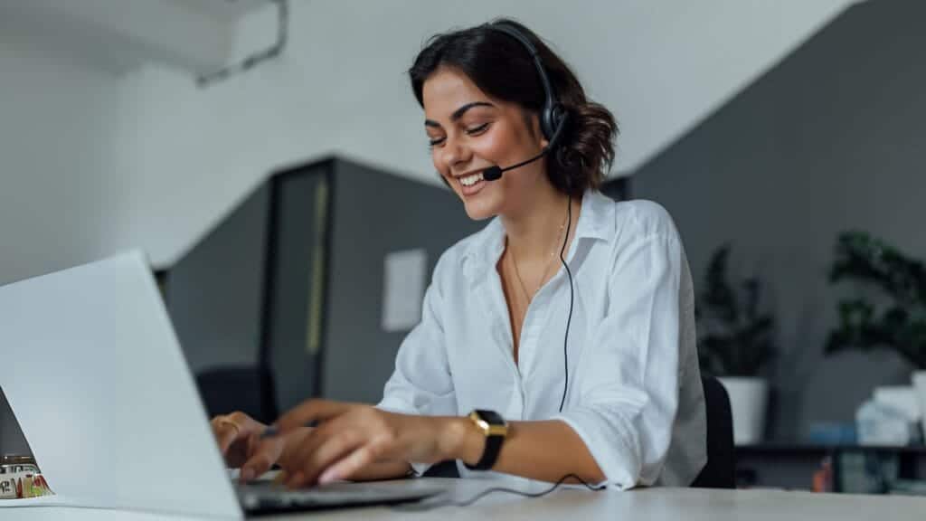 virtual-medical-assistant-services-1-1024x576 Smiling woman with headset working on a laptop in an office setting. | Sky Rye Design Smiling woman with headset working on a laptop in an office setting.