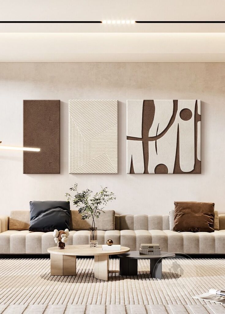 wall art in living space 1 Modern living room with abstract wall art, beige sofa, and coffee table. Minimalist decor and cozy ambiance. | Sky Rye Design Modern living room with abstract wall art, beige sofa, and coffee table. Minimalist decor and cozy ambiance.