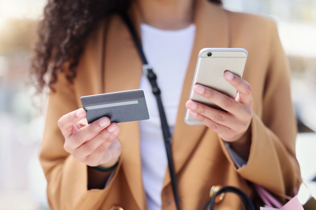 woman-online-shopping-credit-card-payment-and-royalty-free-image-1696863588 Person using smartphone and credit card for mobile payment. | Sky Rye Design Person using smartphone and credit card for mobile payment.