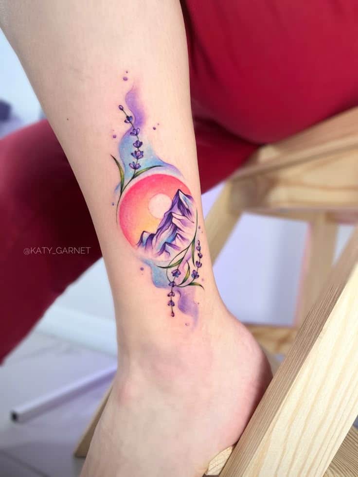 Акварельная тату Colorful tattoo of mountains, sunset, and flowers on ankle. Vibrant watercolor style. | Sky Rye Design Colorful tattoo of mountains, sunset, and flowers on ankle. Vibrant watercolor style.