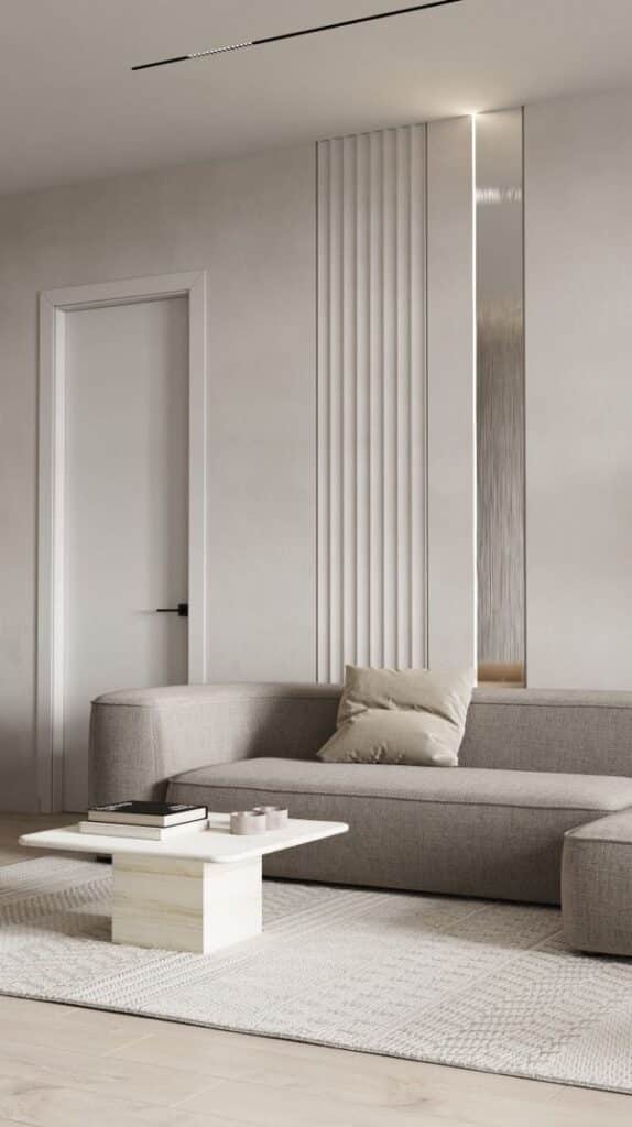 Minimalist living room with beige sofa, modern coffee table, and textured wall design.