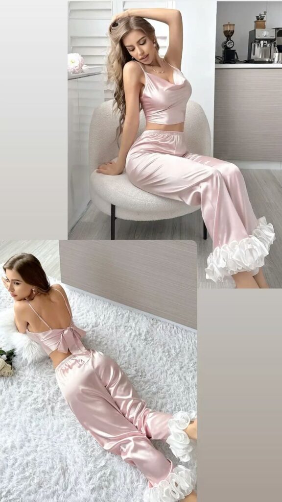 Woman in elegant pink satin lounge set relaxing in a modern interior setting.