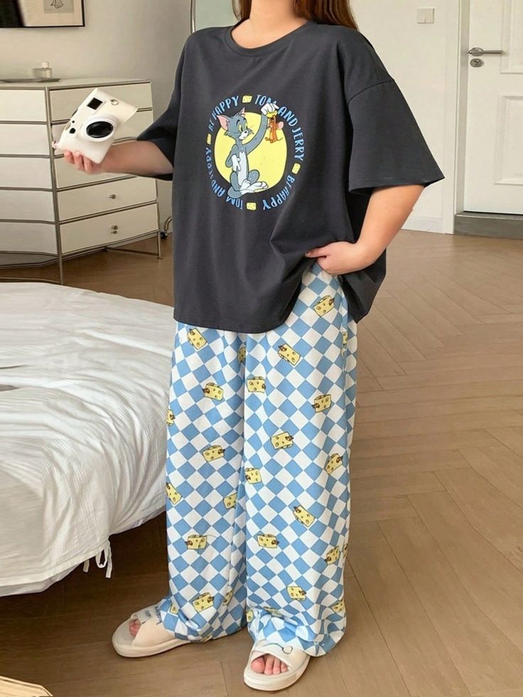 Casual outfit featuring a Tom and Jerry t-shirt with blue checkered cheese-patterned pants and white sandals.