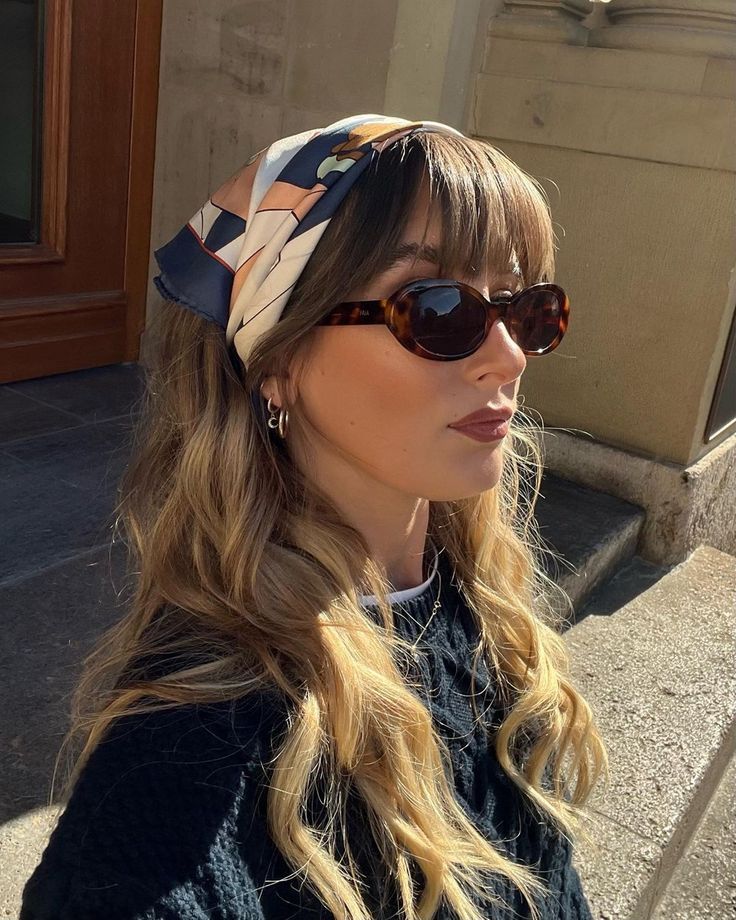 ⚡️🤍 Woman wearing sunglasses and a stylish headscarf with long hair, standing outdoors in sunlight. | Sky Rye Design Woman wearing sunglasses and a stylish headscarf with long hair, standing outdoors in sunlight.