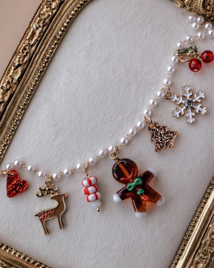 𝙸𝚝𝚜 𝚃𝚑𝚎 𝙼𝚘𝚜𝚝 𝚆𝚘𝚗𝚍𝚎𝚛𝚏𝚞𝚕 Festive charm bracelet with holiday-themed trinkets including snowflake, reindeer, and gingerbread man on a decorative frame. | Sky Rye Design Festive charm bracelet with holiday-themed trinkets including snowflake, reindeer, and gingerbread man on a decorative frame.