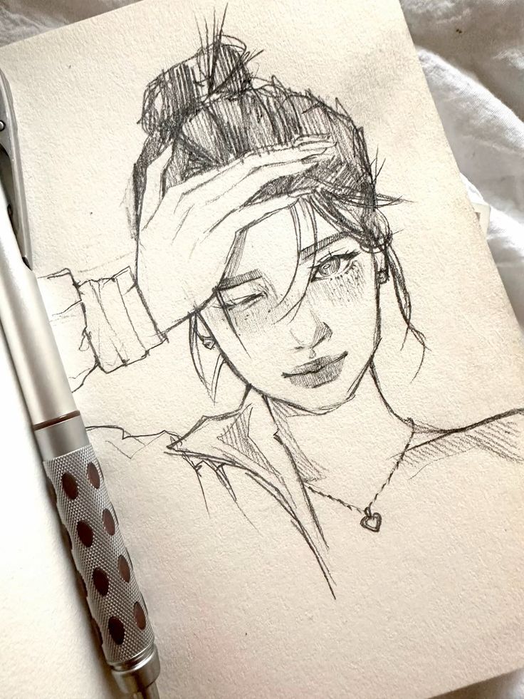 🌙 Sketch of a woman with a bun and heart necklace, hand on forehead, next to a pen on paper. | Sky Rye Design Sketch of a woman with a bun and heart necklace, hand on forehead, next to a pen on paper.