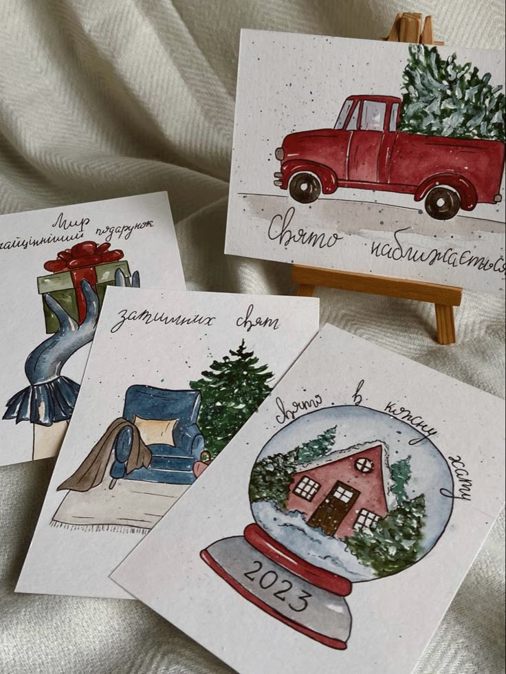Листівки Festive watercolor cards with winter scenes and a red truck. Includes phrases in Cyrillic and a snow globe with 2023. Cozy holiday vibes. | Sky Rye Design Festive watercolor cards with winter scenes and a red truck. Includes phrases in Cyrillic and a snow globe with 2023. Cozy holiday vibes.