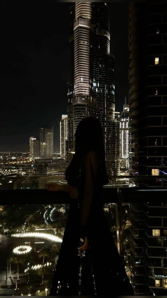 авымЫВм Silhouette of a woman admiring a cityscape with illuminated skyscrapers at night. | Sky Rye Design Silhouette of a woman admiring a cityscape with illuminated skyscrapers at night.