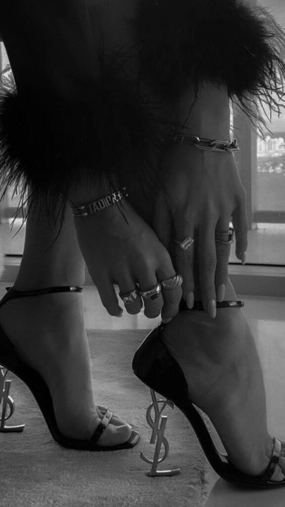 ваив Elegant high heels with YSL logo and stylish rings on hands, black and white fashion photography. | Sky Rye Design Elegant high heels with YSL logo and stylish rings on hands, black and white fashion photography.