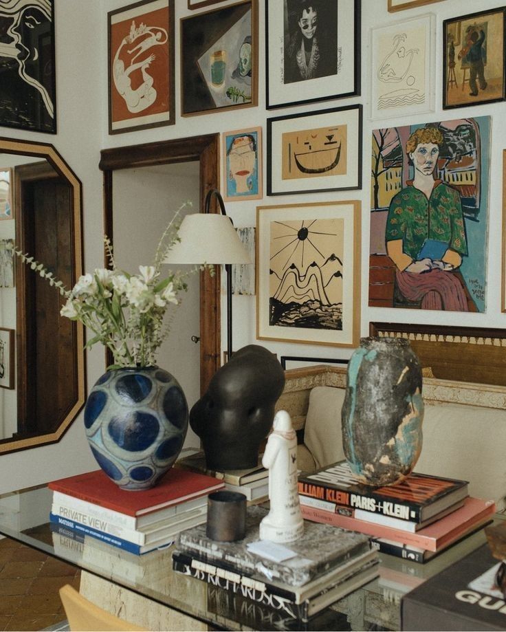 🌿 Eclectic art-filled room with modern sculptures and colorful paintings on the wall, enhancing the cozy atmosphere. | Sky Rye Design Eclectic art-filled room with modern sculptures and colorful paintings on the wall, enhancing the cozy atmosphere.