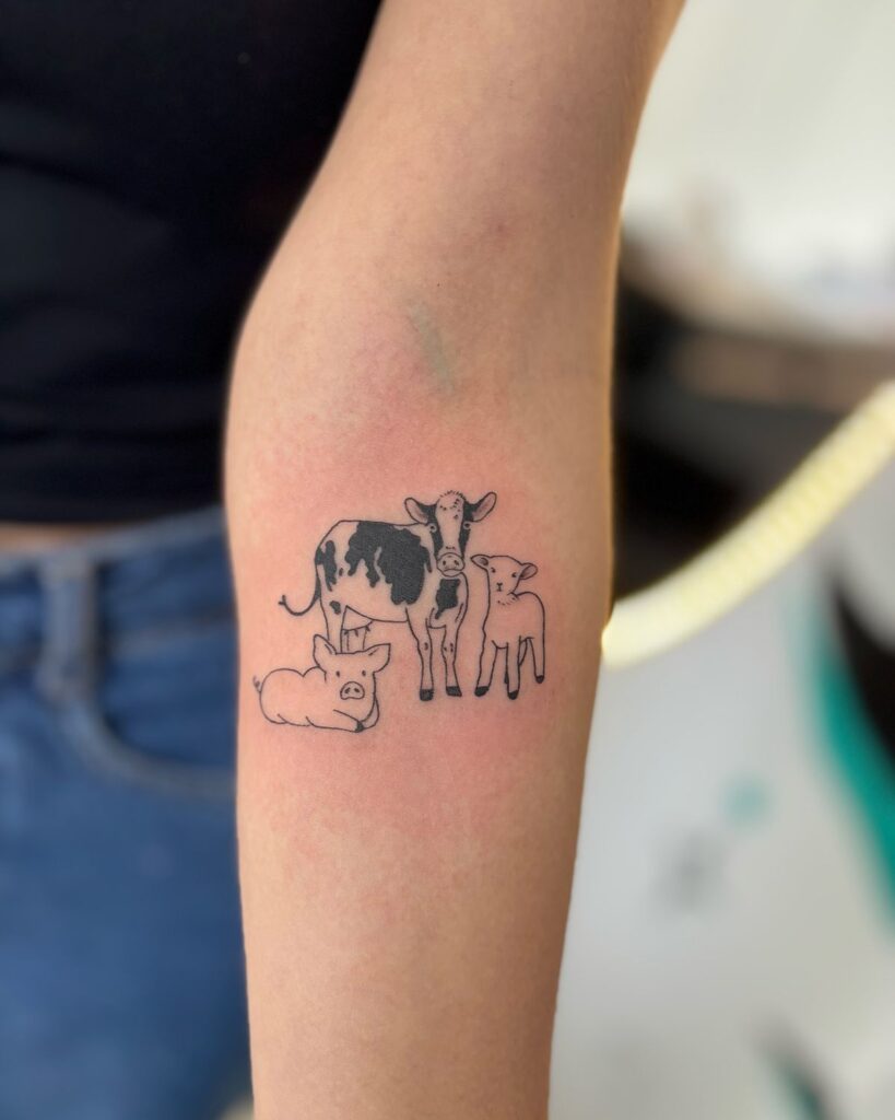 030de66c069061f95a1c53f3a5fcff38 Minimalist tattoo of a cow, calf, and pig on a person's arm, showcasing farm animal art. | Sky Rye Design Minimalist tattoo of a cow, calf, and pig on a person's arm, showcasing farm animal art.