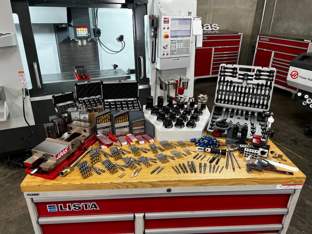 08-1739A CNC machine setup with tools and accessories organized on a workshop table for precision machining tasks. | Sky Rye Design CNC machine setup with tools and accessories organized on a workshop table for precision machining tasks.
