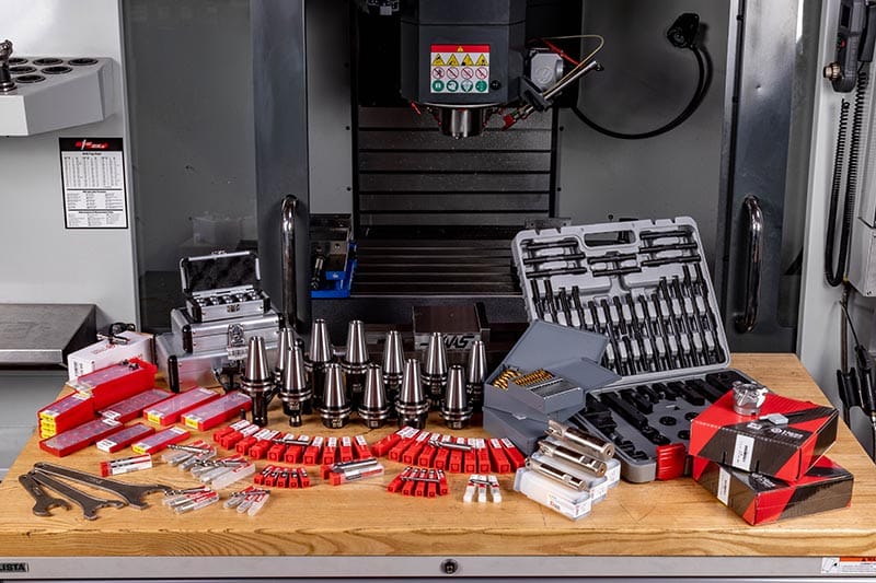 08-1822 CNC machine tools and accessories organized on a workbench in a workshop setting. | Sky Rye Design CNC machine tools and accessories organized on a workbench in a workshop setting.