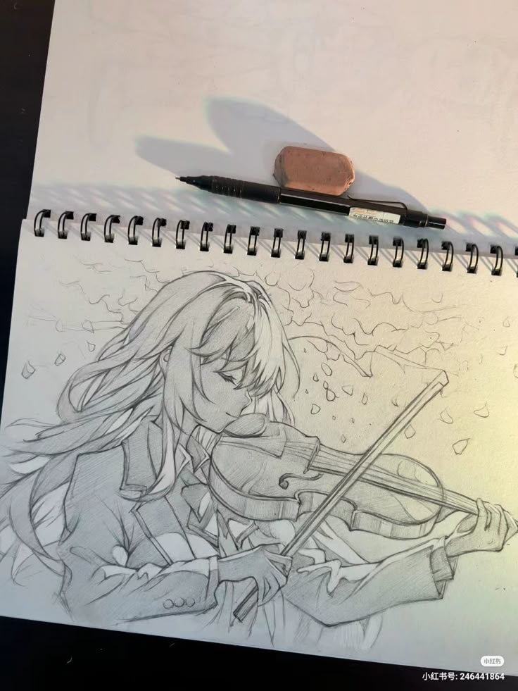 Sketch of a girl playing the violin with flowing hair, surrounded by falling leaves in a notebook.