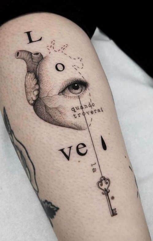 _ 1 Surreal heart and eye tattoo with the word love and a key design on forearm, featuring artistic details. | Sky Rye Design Surreal heart and eye tattoo with the word love and a key design on forearm, featuring artistic details.