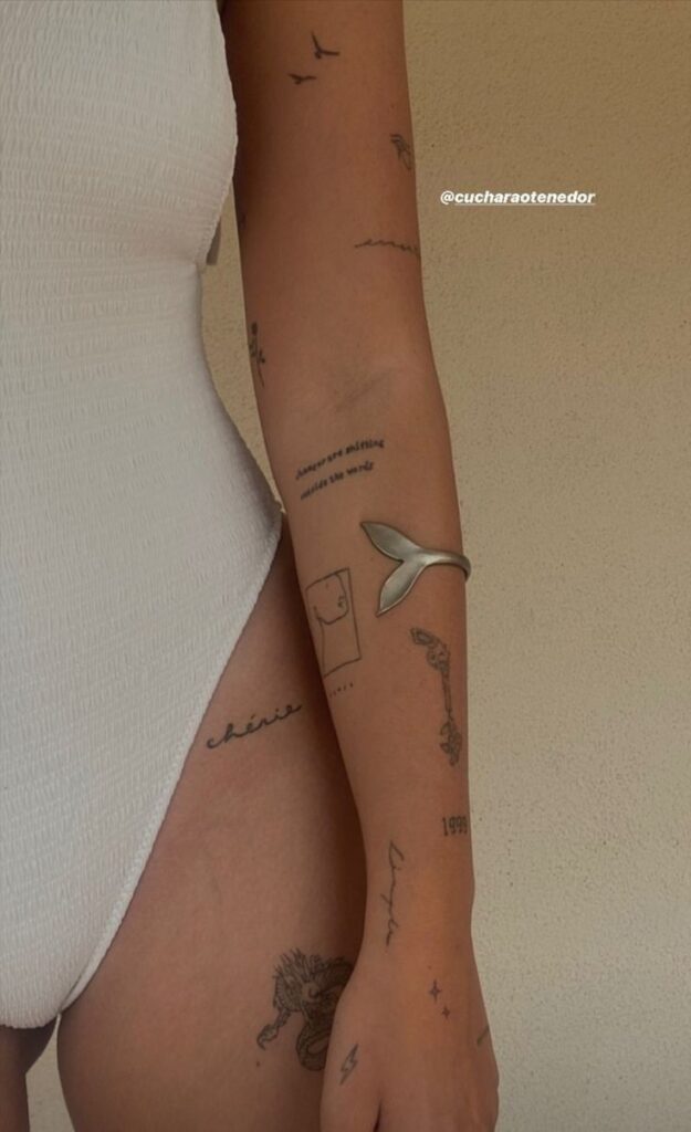 _ 10 Close-up of a person's arm and torso with minimalist tattoos and a white swimsuit against a neutral background. | Sky Rye Design Close-up of a person's arm and torso with minimalist tattoos and a white swimsuit against a neutral background. easy tattoo ideas