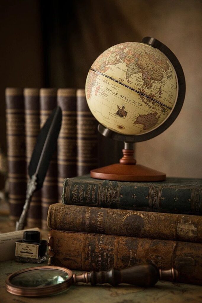 Vintage globe, old books, quill, and magnifying glass on a desk evoke a sense of exploration and history in a cozy study setting.