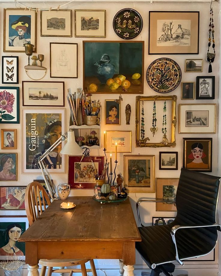 _ 12 Eclectic art wall in cozy room with vintage desk, diverse paintings, and modern chair, creating a creative workspace. | Sky Rye Design Eclectic art wall in cozy room with vintage desk, diverse paintings, and modern chair, creating a creative workspace.