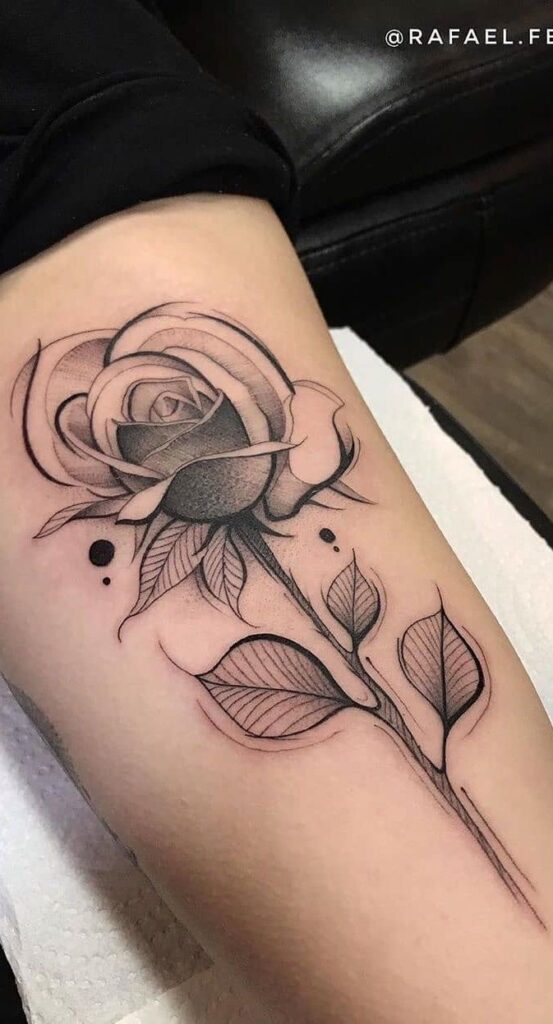 Black and gray rose tattoo on forearm, showcasing intricate shading and dot work details on a relaxed arm.