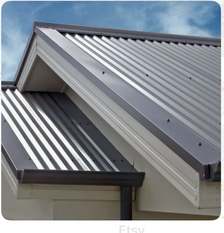 Modern metal roofing panels on a residential building, showcasing durability and sleek design against a clear blue sky.