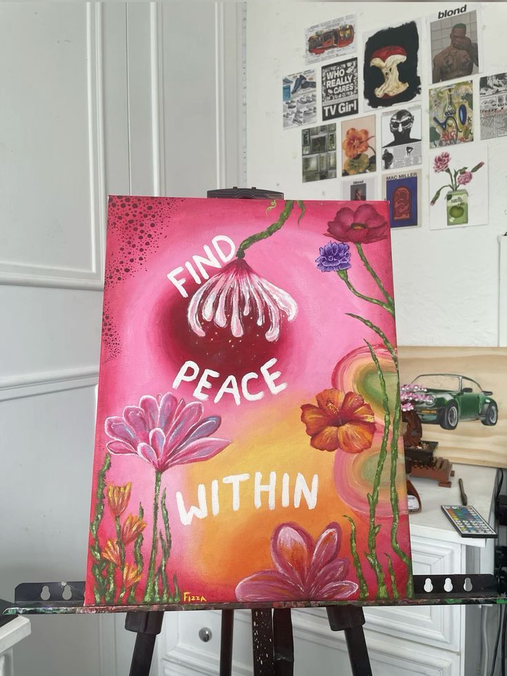 Colorful floral painting with Find Peace Within text, surrounded by art and decor in artist's studio.