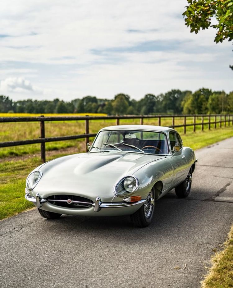 17786bef3f32e8f63fe4bf5db0d3a674 Classic silver car parked on a scenic country road with green fields and fence, under a partly cloudy sky. | Sky Rye Design Classic silver car parked on a scenic country road with green fields and fence, under a partly cloudy sky.