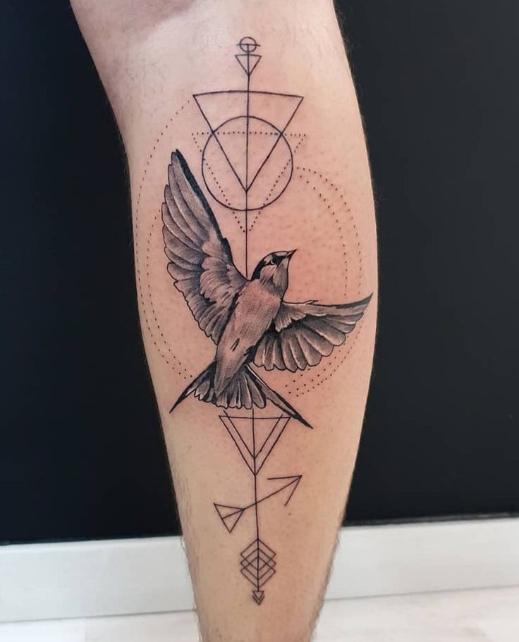 _ 18 Bird tattoo with geometric design and dotted patterns on the leg against a black background. | Sky Rye Design Bird tattoo with geometric design and dotted patterns on the leg against a black background.