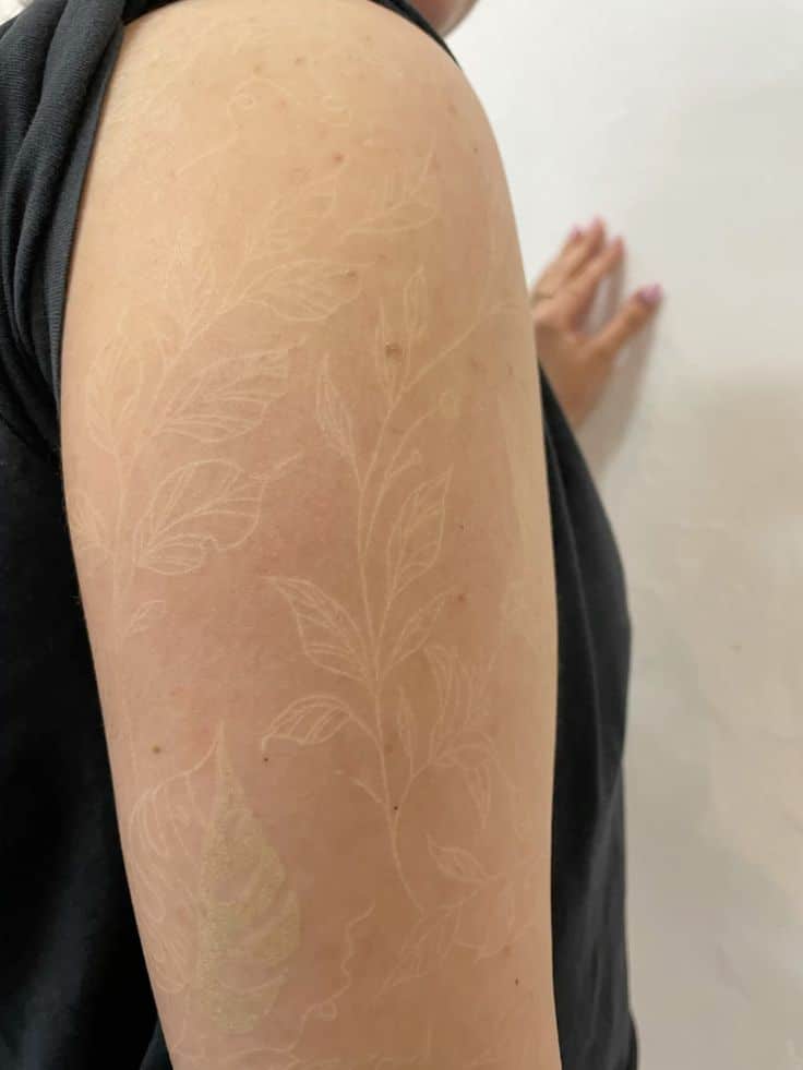 1c25293f3f441ed9b8ebfa6f680b83cb White ink floral tattoo on person’s arm, close-up view against a light background. | Sky Rye Design White ink floral tattoo on person’s arm, close-up view against a light background.