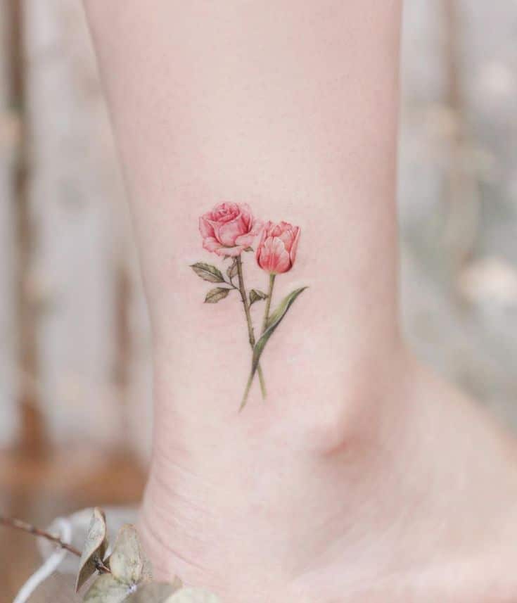 Delicate pink rose tattoo on ankle, showcasing minimalist floral design with soft pastel shades. Ideal for subtle and elegant body art.