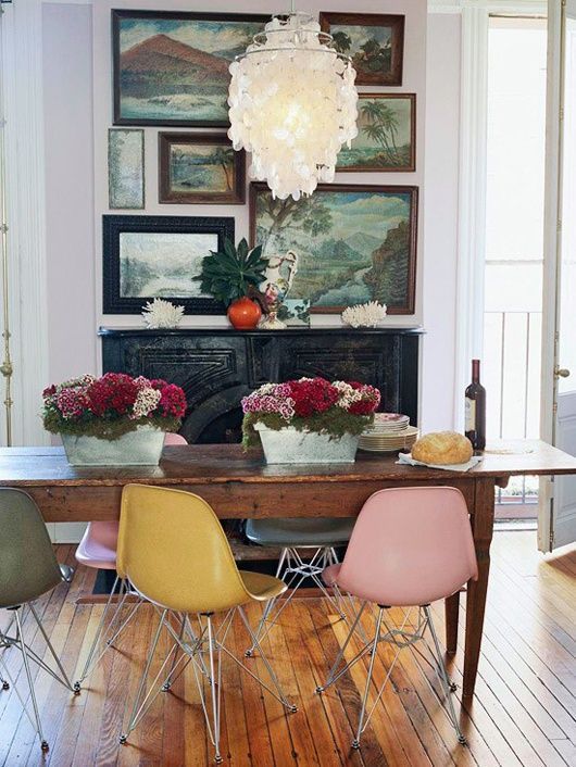_ 2 Eclectic dining room with colorful chairs, wooden table, floral centerpieces, vintage paintings, and chandelier. | Sky Rye Design Eclectic dining room with colorful chairs, wooden table, floral centerpieces, vintage paintings, and chandelier.