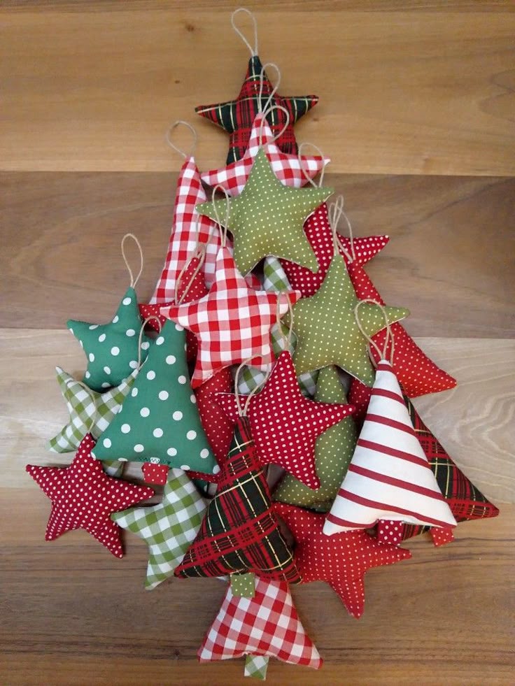 2021 Christmas ornaments Christmas ornaments made of fabric Christmas tree ornaments 2021 Colorful fabric star and tree ornaments arranged in a creative Christmas tree shape on a wooden background. | Sky Rye Design Colorful fabric star and tree ornaments arranged in a creative Christmas tree shape on a wooden background.