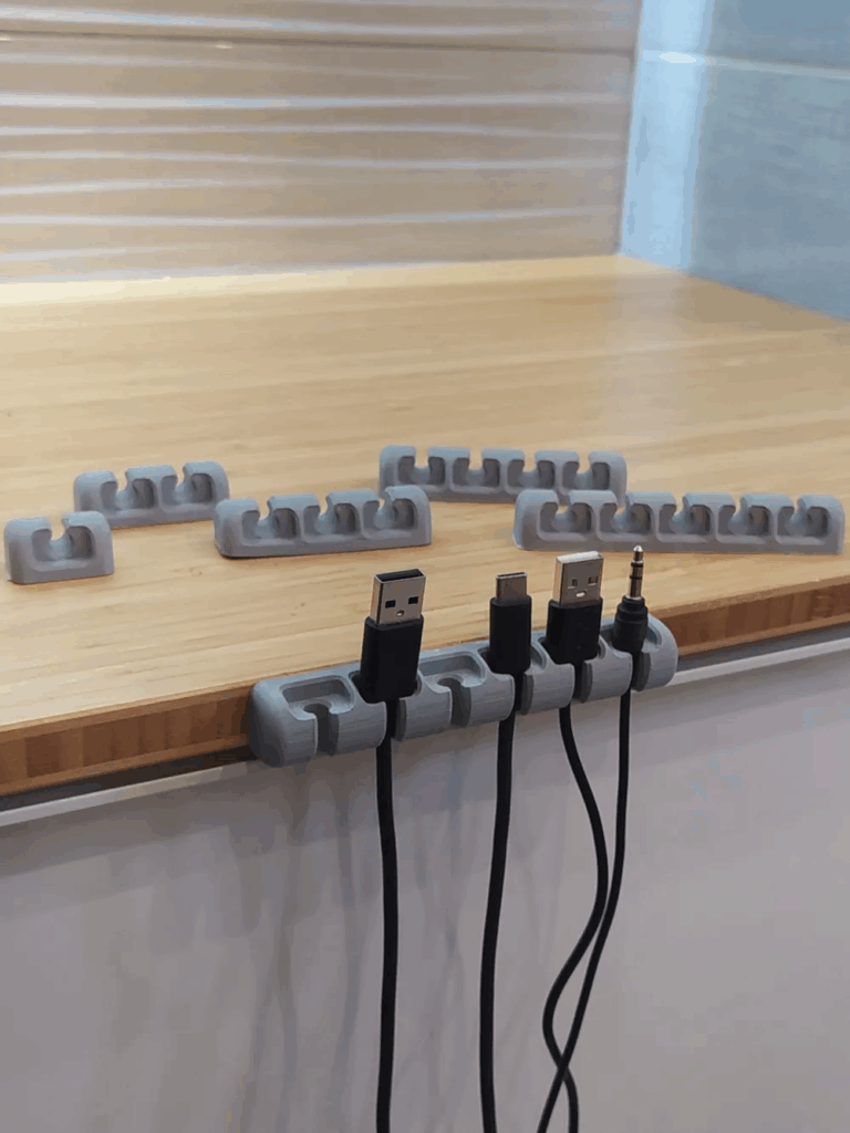 2024-04-20_15cdd6fd37c05 Cable organizers with cords on a desk, showcasing efficient cable management in a workspace setup. | Sky Rye Design Cable organizers with cords on a desk, showcasing efficient cable management in a workspace setup.