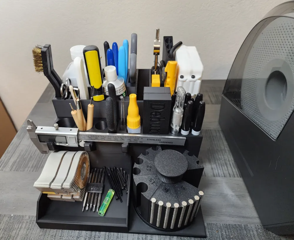 Compact workshop organizer holding various tools and stationery, including brushes, markers, and measuring instruments on a desk.