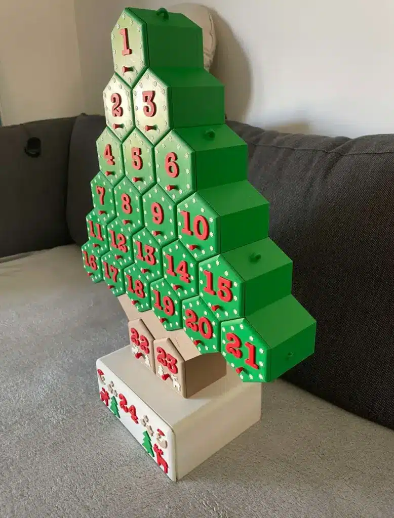 Christmas tree-shaped advent calendar with numbered green and red boxes on a couch, perfect for holiday countdown decor.