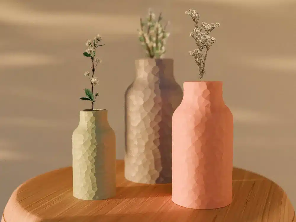 2024-11-01_44f79cbb1b64c8 Three textured vases with minimalist floral arrangements on a wooden surface, in warm lighting. | Sky Rye Design Three textured vases with minimalist floral arrangements on a wooden surface, in warm lighting.