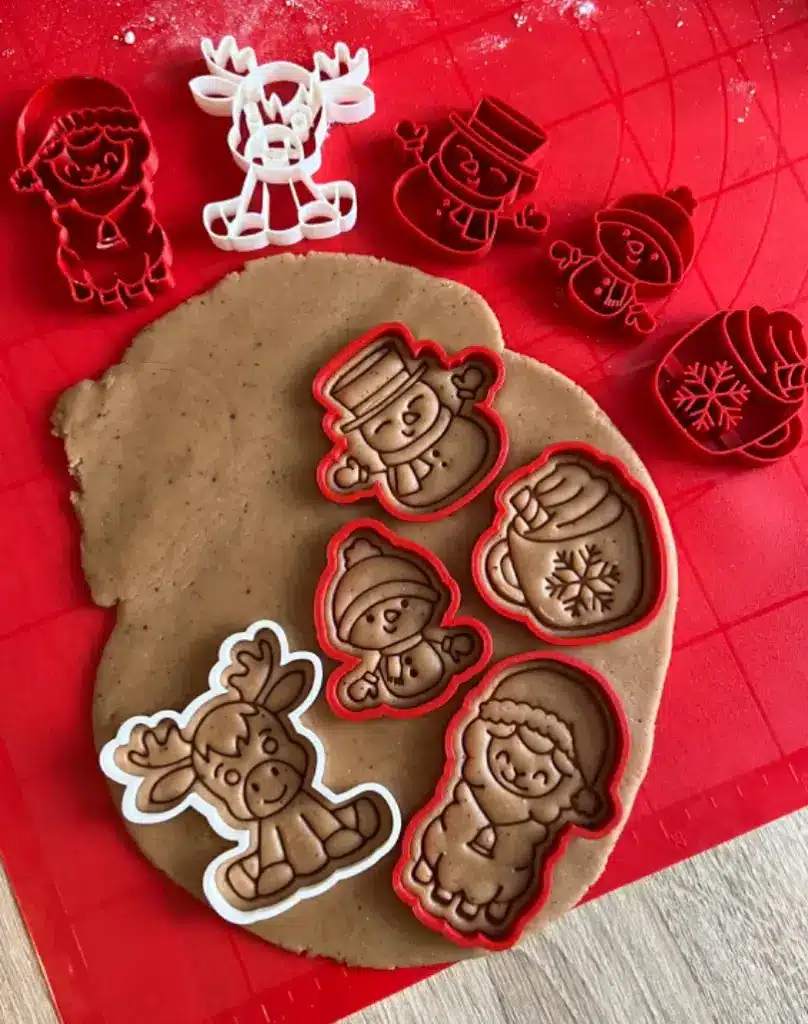 2024-11-04_1fc8774f09043 Festive cookie cutters and dough with holiday designs, including a snowman, reindeer, and elf, creating a fun Christmas baking scene. | Sky Rye Design Festive cookie cutters and dough with holiday designs, including a snowman, reindeer, and elf, creating a fun Christmas baking scene.