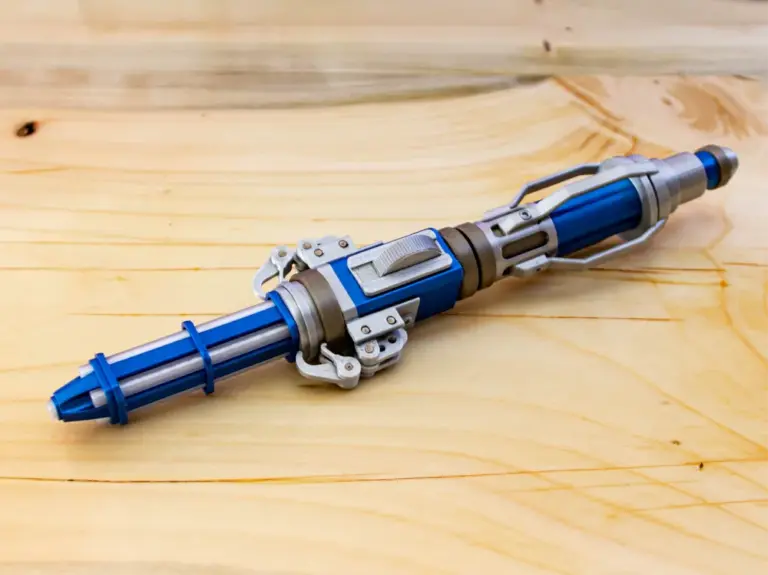 2025-03-16_33a40d1234ebf Futuristic blue and silver tool with intricate design resting on a wooden surface, resembling a sci-fi gadget or prop. | Sky Rye Design Futuristic blue and silver tool with intricate design resting on a wooden surface, resembling a sci-fi gadget or prop.