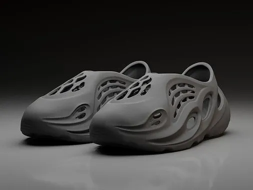 Futuristic gray clogs with artistic cutouts and textured design, set against a dark background. Perfect blend of comfort and style.