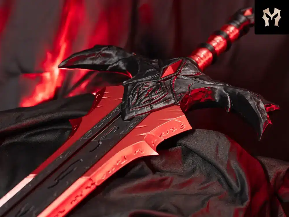 Intricately designed red and black fantasy sword with dramatic lighting and fabric background, symbolizing power and mystery.