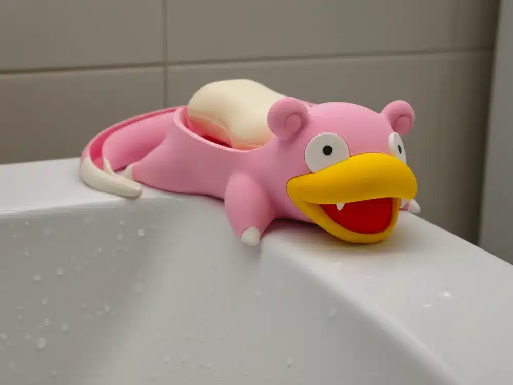 2025-10-31_4af6b4bd5ce3f8 Pink Slowpoke soap holder on a wet bathtub, adding a playful touch to the bathroom decor. | Sky Rye Design Pink Slowpoke soap holder on a wet bathtub, adding a playful touch to the bathroom decor.