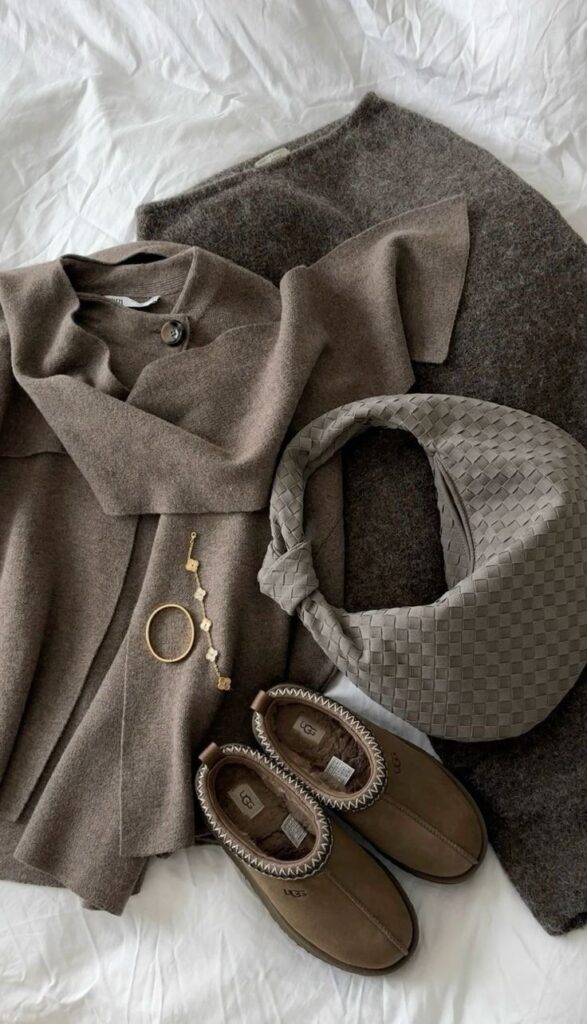 Stylish winter outfit with brown coat, woven handbag, cozy shoes, and gold jewelry on a white background. Perfect for a chic look.