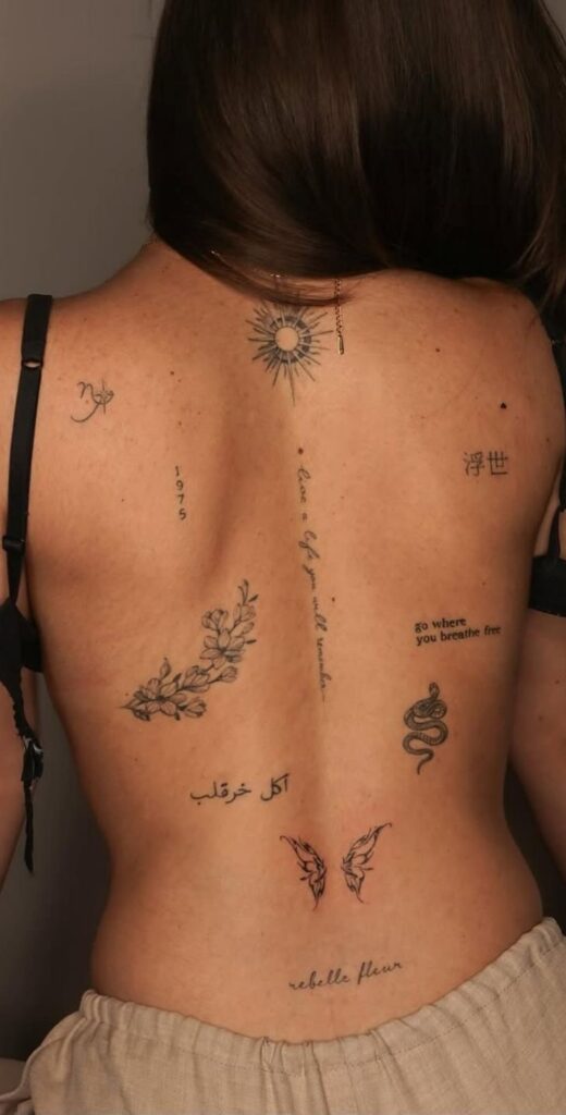 21 Feminine Back Tattoo Ideas Too Hot to Ignore 2025 Back adorned with various intricate tattoos, featuring floral, script, and symbolic designs, showcasing unique personal expression. | Sky Rye Design Back adorned with various intricate tattoos, featuring floral, script, and symbolic designs, showcasing unique personal expression.