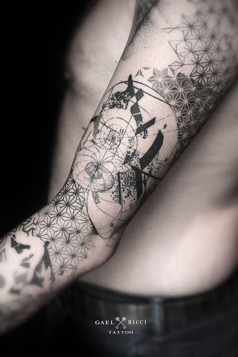 Abstract geometric tattoo on a man's arm, featuring intricate patterns and shading.