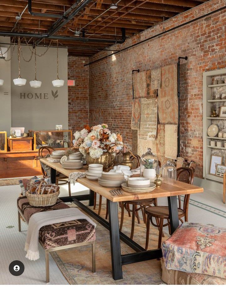 _ 24 Rustic dining room with brick walls, wooden table set for dinner, vintage decor, and floral centerpiece arrangement. | Sky Rye Design Rustic dining room with brick walls, wooden table set for dinner, vintage decor, and floral centerpiece arrangement.