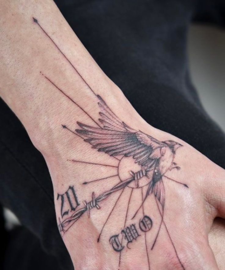 _ 26 Bird and barbed wire tattoo on hand with 20 Two text. Unique design with rays emanating outward. | Sky Rye Design Bird and barbed wire tattoo on hand with 20 Two text. Unique design with rays emanating outward.