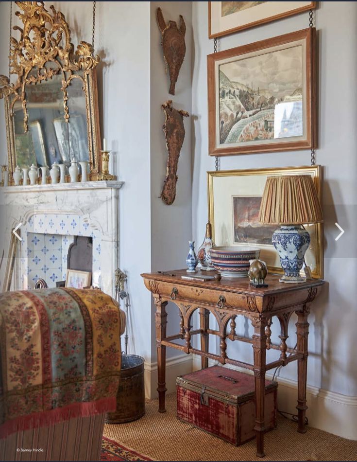 _ 27 Vintage-style room with ornate mirror, wooden table, art, and decorative lamp. Cozy ambiance with antique decor. | Sky Rye Design Vintage-style room with ornate mirror, wooden table, art, and decorative lamp. Cozy ambiance with antique decor.