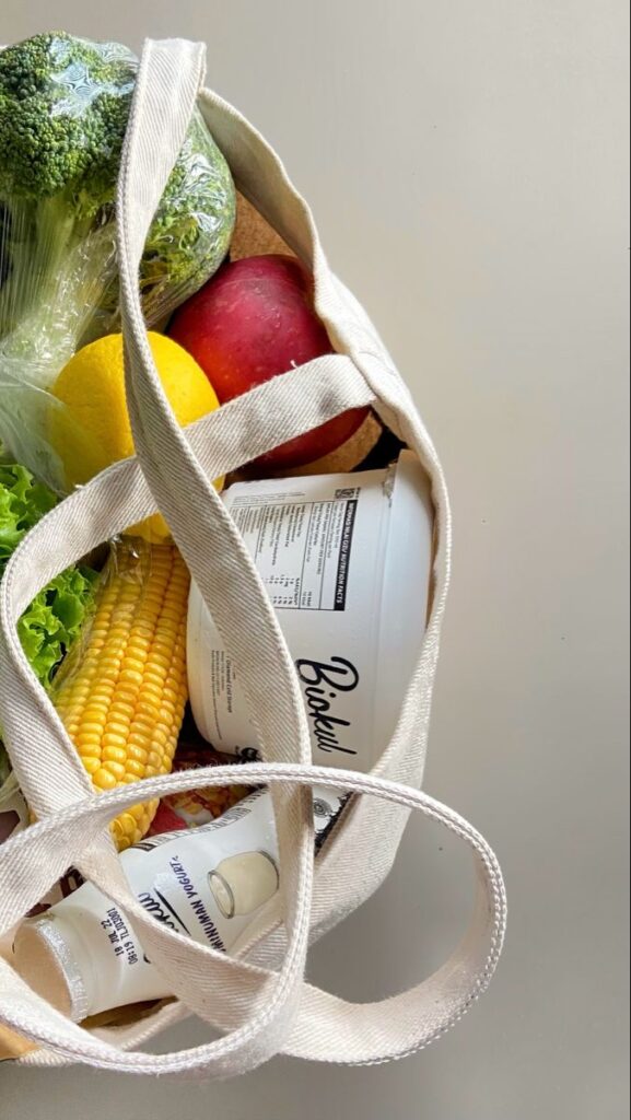 _ 3 Reusable tote bag filled with fresh produce, yogurt, and groceries for a healthy lifestyle. | Sky Rye Design Reusable tote bag filled with fresh produce, yogurt, and groceries for a healthy lifestyle.