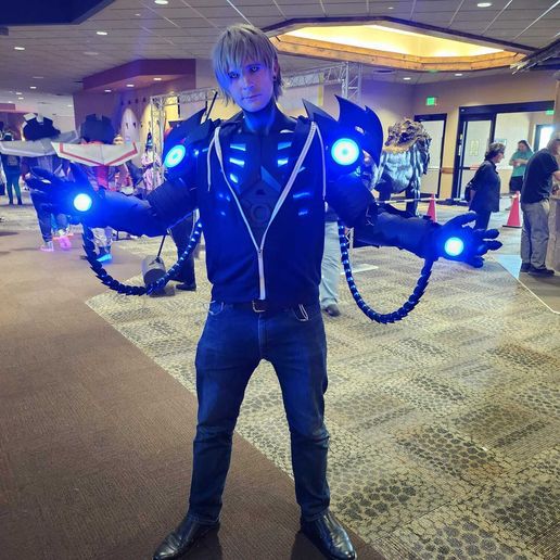 353662058_10230379836815569_1435904892119586488_n Cosplayer in futuristic outfit with glowing blue lights at a convention hall. | Sky Rye Design Cosplayer in futuristic outfit with glowing blue lights at a convention hall.